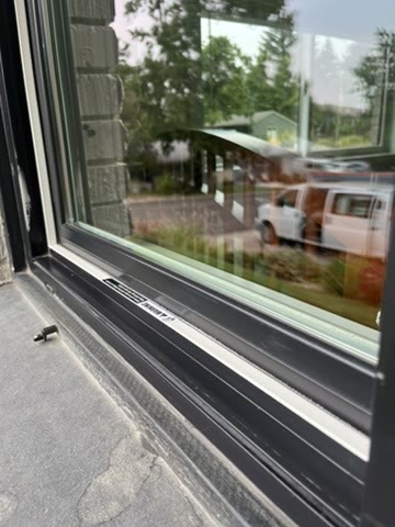 The same window after cleaning, the glass clear and the frame and track wiped down