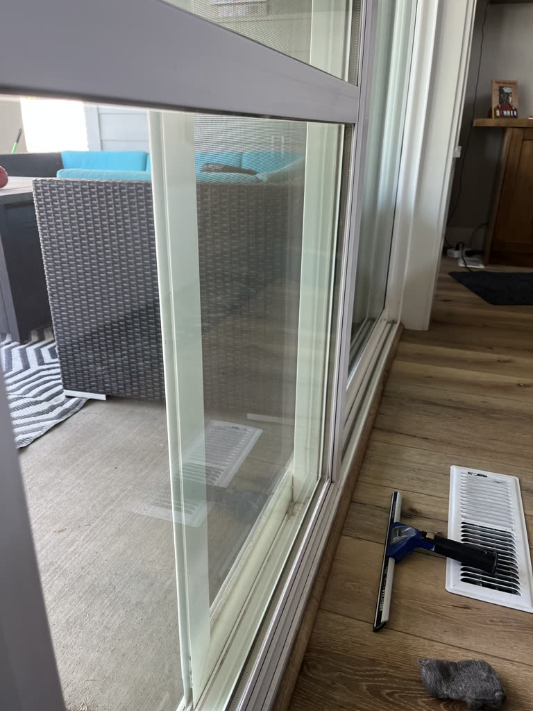 The same sliding door after cleaning, the glass clear through to the patio