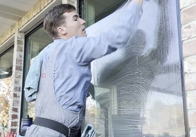 A Seymour's technician washing exterior glass