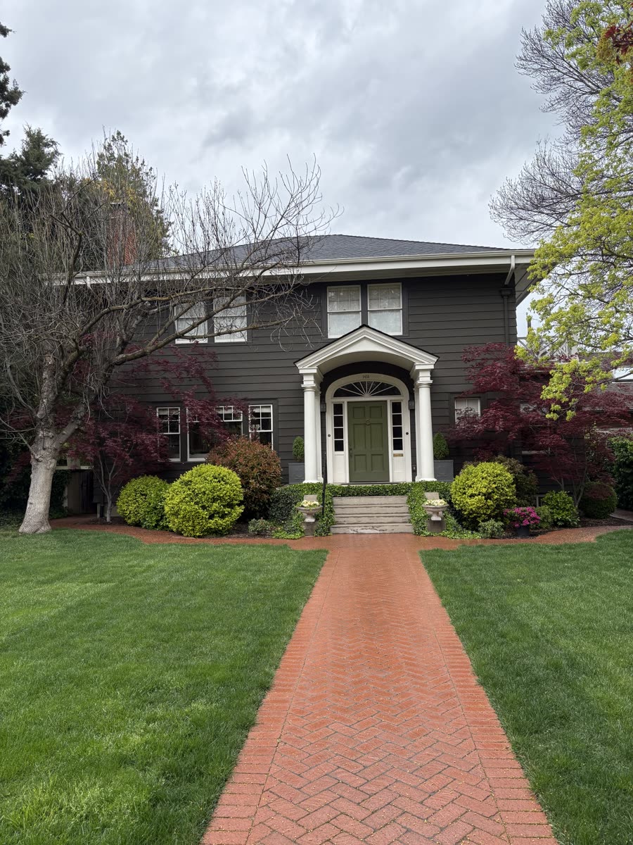 A classic two-story Boise home at the end of a brick front walk