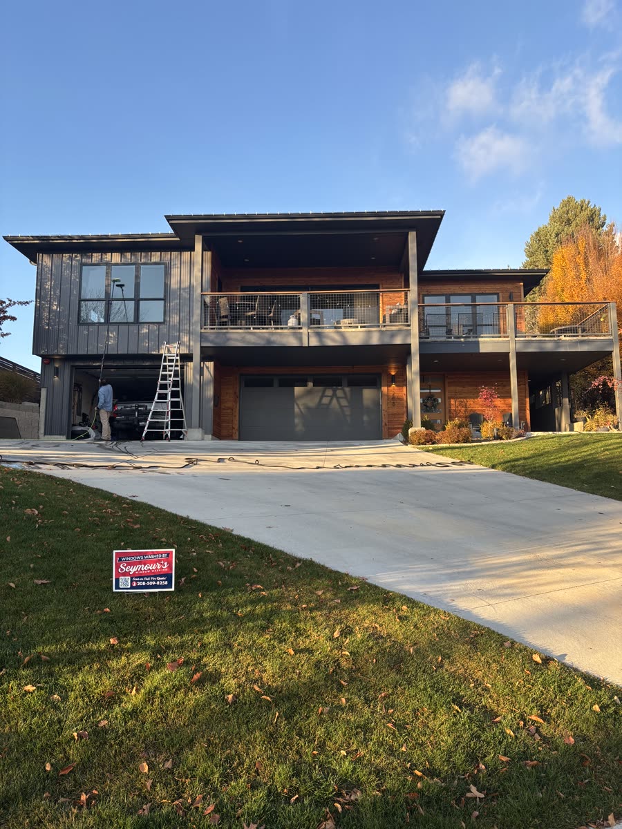 A ladder up at a modern Boise home mid-job, a yard sign on the lawn