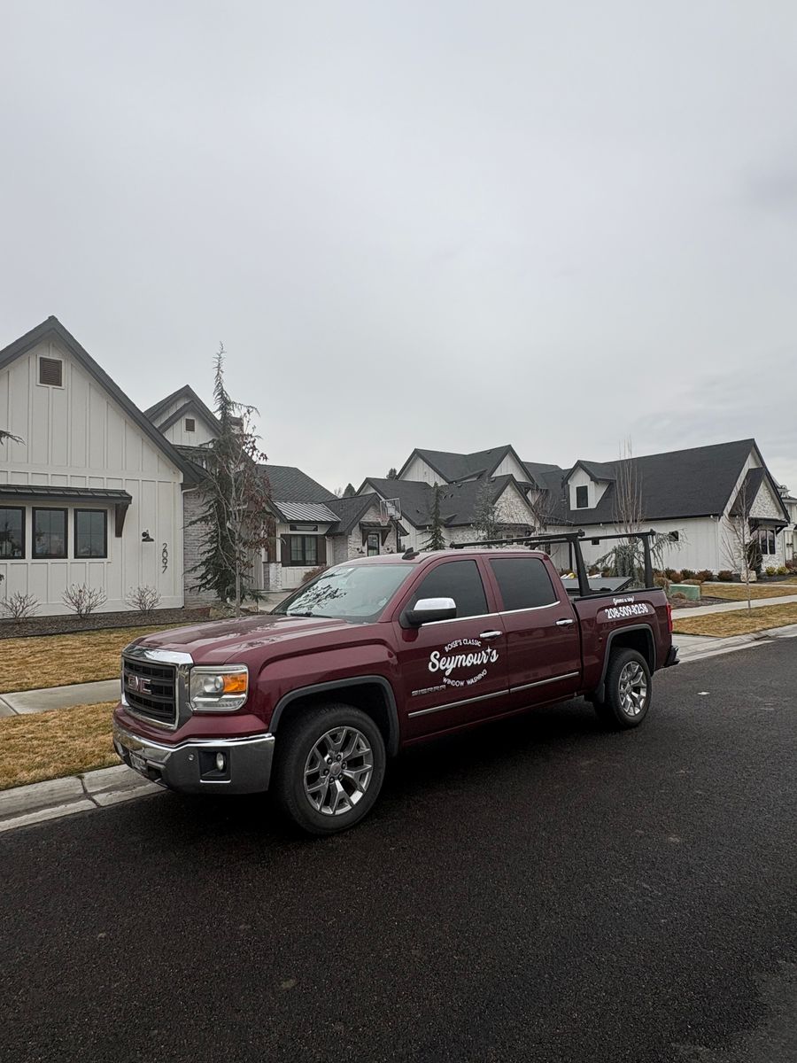 The Seymour's truck parked on a street of white farmhouse-style homes in Eagle