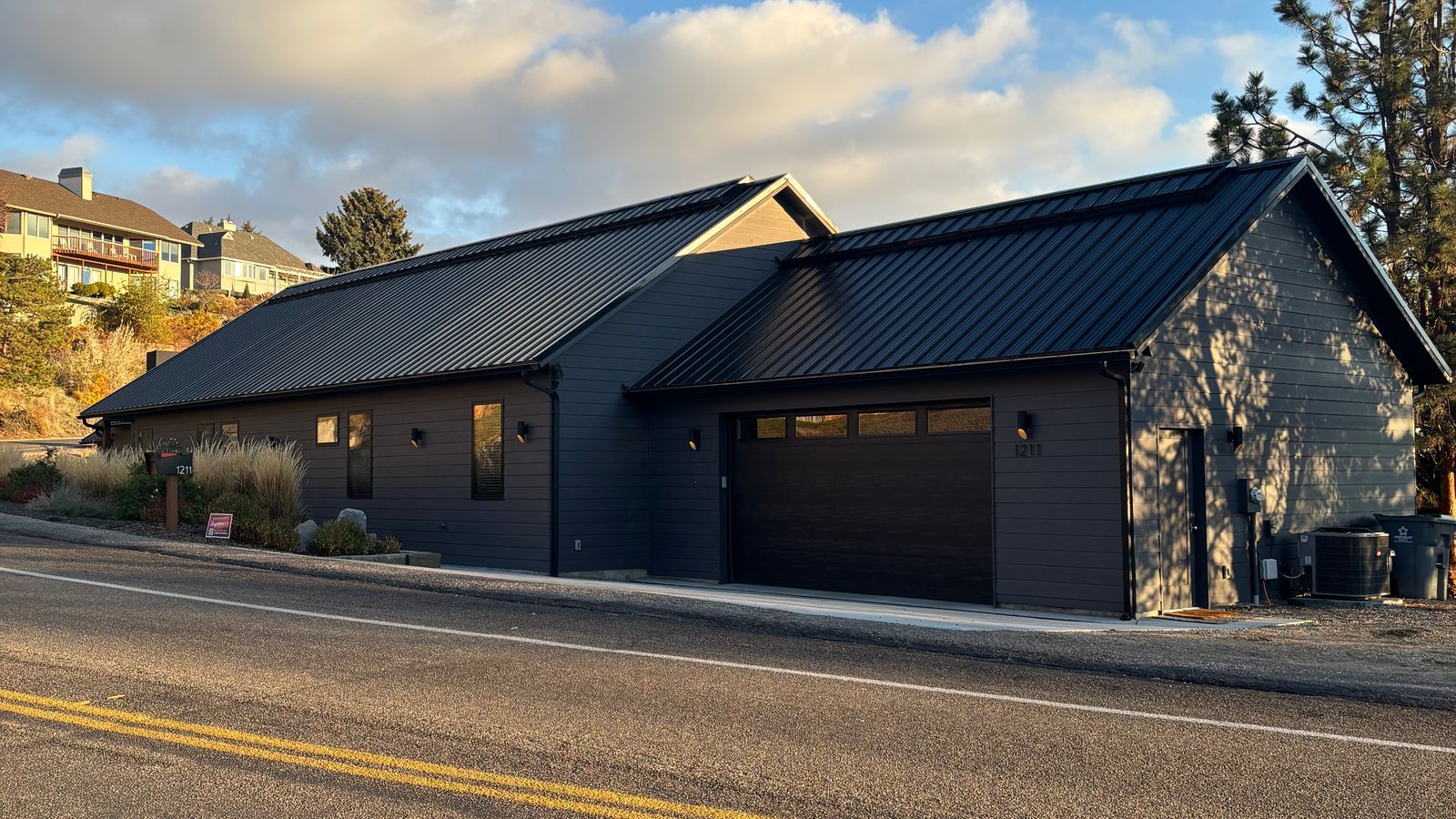 A dark modern farmhouse-style home on a Boise street