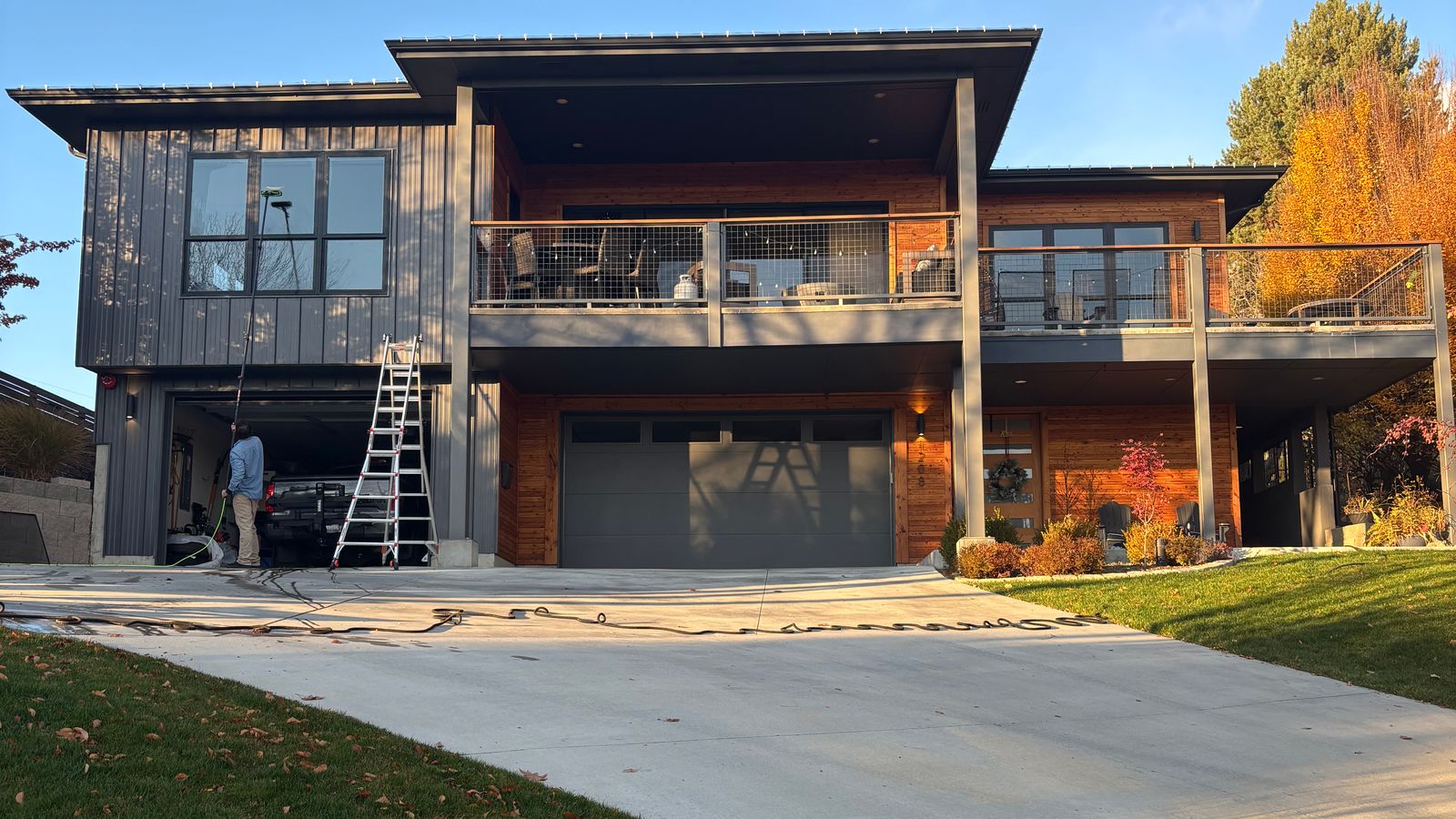 A Seymour's tech at work at the garage of a modern Boise home, a ladder up beside him