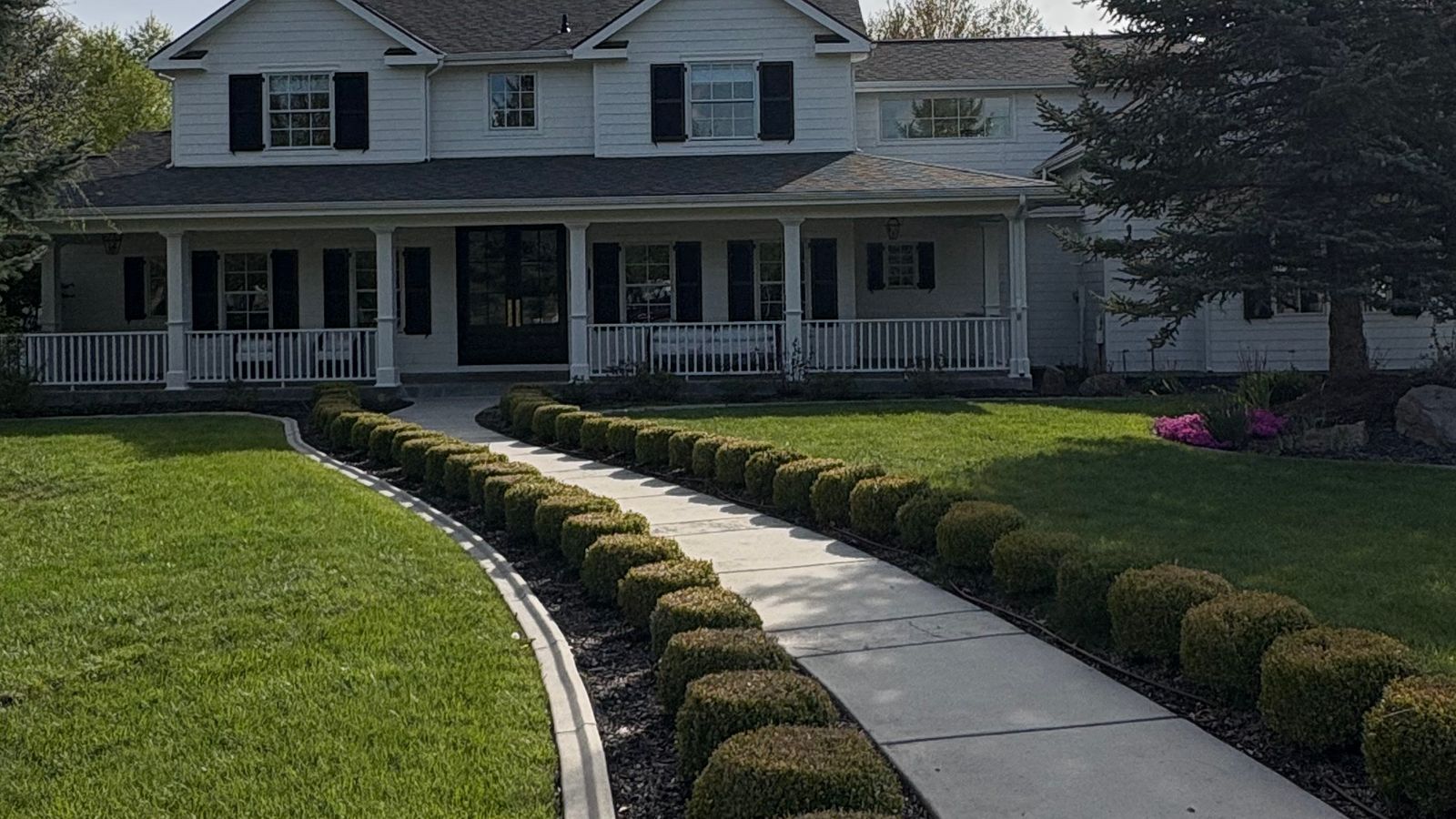 A white Eagle home with a long front porch and a curved front walk