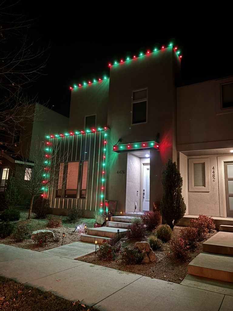 Evenly spaced bulbs following the peak of a roofline